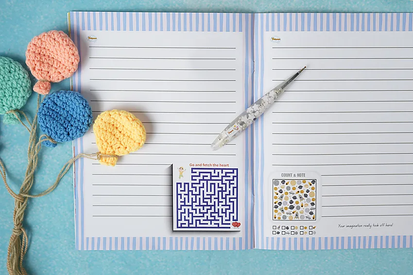 Lined writing pages with a maze and a puzzle activity printed alongside
